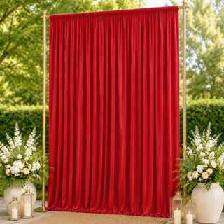 Red wedding backdrop curtain with gold frame, floral arrangements, and lanterns