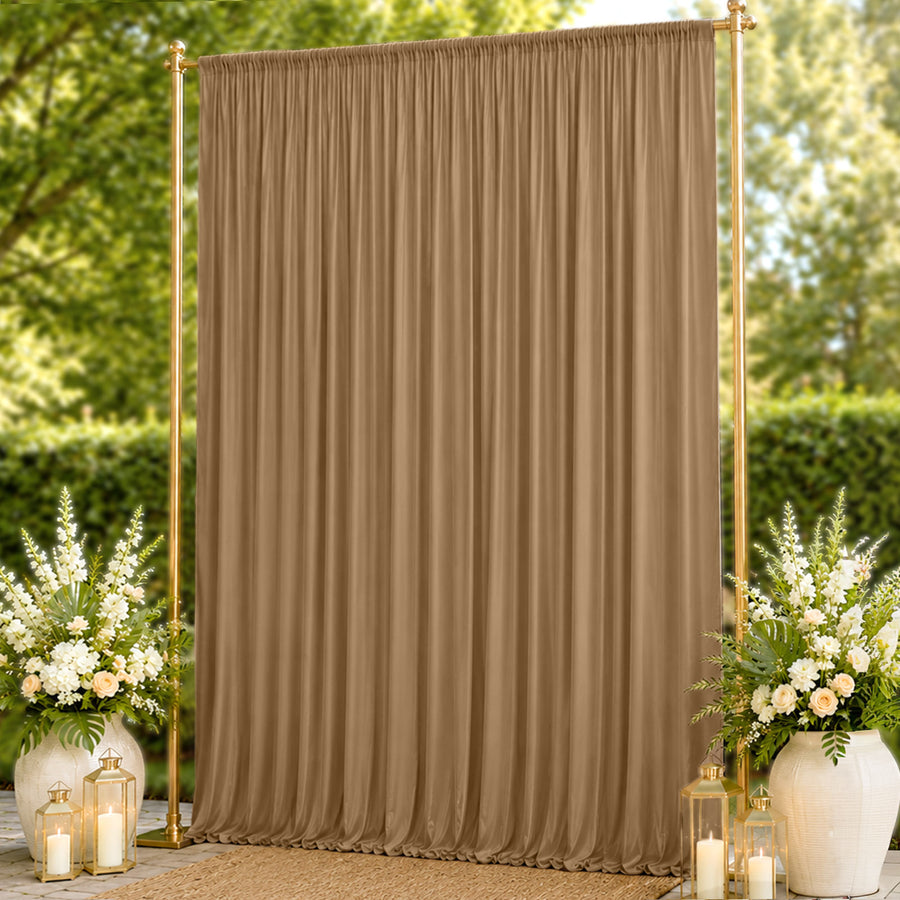 Gold backdrop curtain with floral arrangements and lanterns for outdoor events