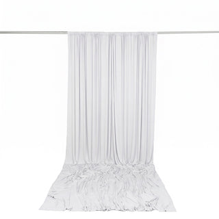 White sheer curtain draped on a metal rod against a white background