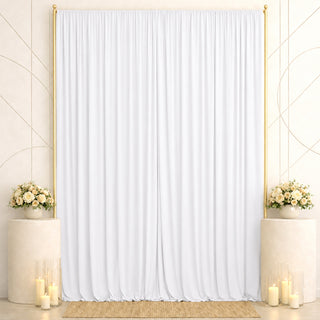 Elegant white wedding backdrop with gold frames, floral arrangements, and candles