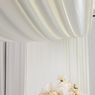 Elegant floral arrangement with soft fabrics in the background.