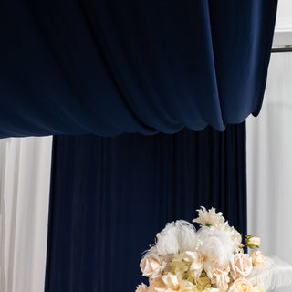 Floral arrangement under elegant drapery backdrop.