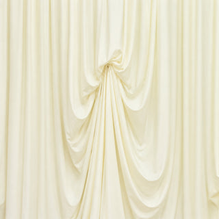 Cream draped fabric backdrop with elegant gathered folds