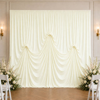 Elegant ivory wedding backdrop with draped curtain and floral arrangements