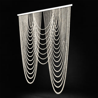 Elegant beaded curtain drapes in cascading layers on a dark background.