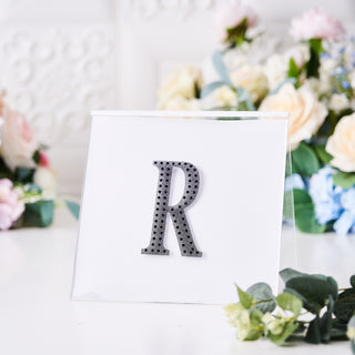 Decorative letter "R" in silver with rhinestones on clear display
