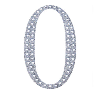 Glittery silver number "0" cutout on a white background