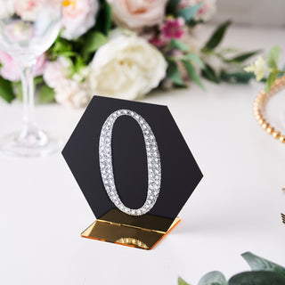 Hexagon table number sign with sparkling "0" in diamonds on a gold base.