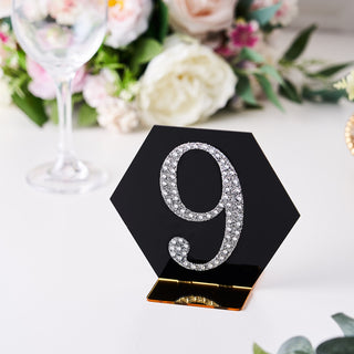 Elegant black table number 9 with crystal embellishments in a floral setting.