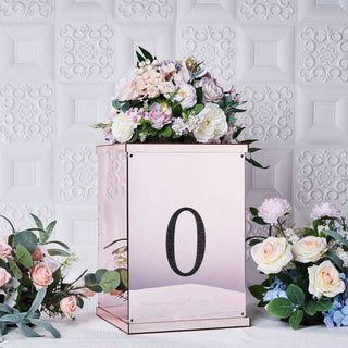 Decorative floral display in a mirrored box with the number "0" in a stylish setup.