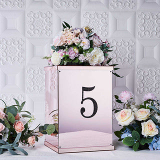 Mirrored floral arrangement stand with number 5 and pastel flowers.