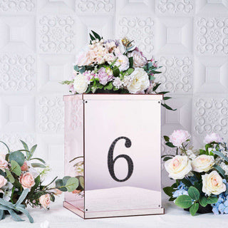 Rose gold table number holder with floral arrangement and number 6.