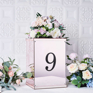 Rose gold table number holder with floral arrangement, number 9 displayed.