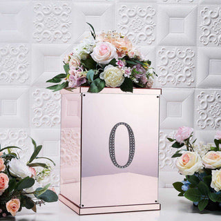 Rose gold floral arrangement box with number zero, surrounded by flowers.