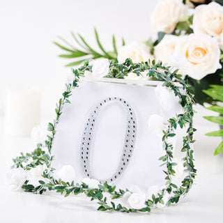 Decorative numeral "0" with floral accents on a clear background