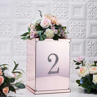Rose gold centerpiece box with number 2 and floral arrangement.