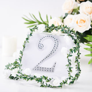 Decorative table number 2 with floral accents and greenery.