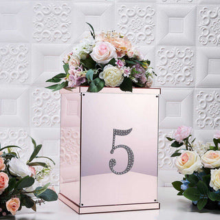 Mirrored floral arrangement box with number 5 and decorative flowers.