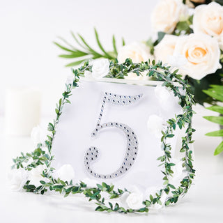 Table number 5 with decorative greenery and flowers for events or weddings.