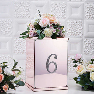Rose gold table number holder with floral arrangement, number 6 displayed.