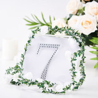 Table number sign 7 adorned with greenery and flowers