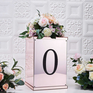 Mirrored flower box with floral arrangement and number zero, elegant decor piece.