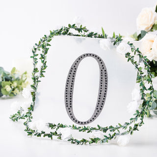 Decorative mirror number '0' surrounded by floral greenery