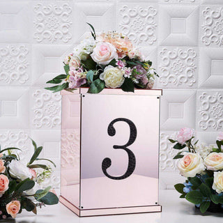 Rose gold table number display with floral arrangement, number 3.