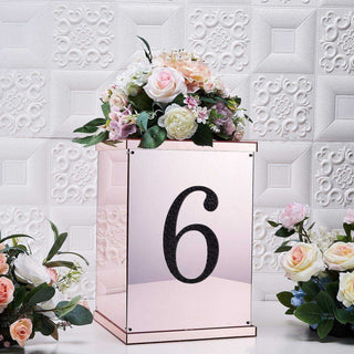 Rose gold floral centerpiece with the number 6 on a mirrored box.
