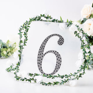 Table number 6 with floral decoration on a clear backdrop.
