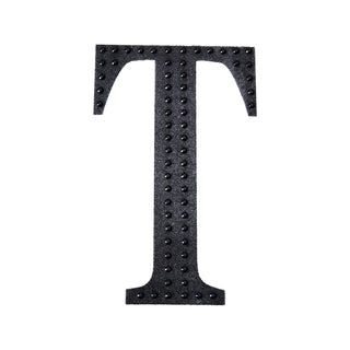 Black textured letter "T" on a plain background.