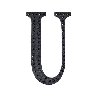 Black letter "U" with textured dots on a white background