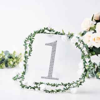 Decorative table number sign with floral wreath, featuring the number one.