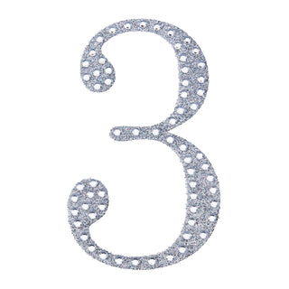 Glittery silver number three cutout on a white background