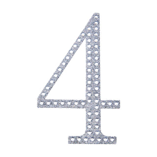Glittery silver number 4 cutout on a plain background.