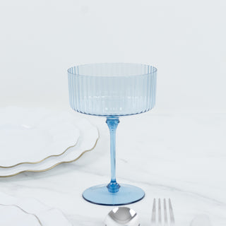 Blue ribbed dessert glass on a white background