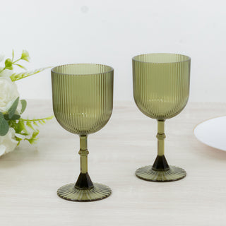 Green ribbed glassware set on a wooden table with decorative elements.