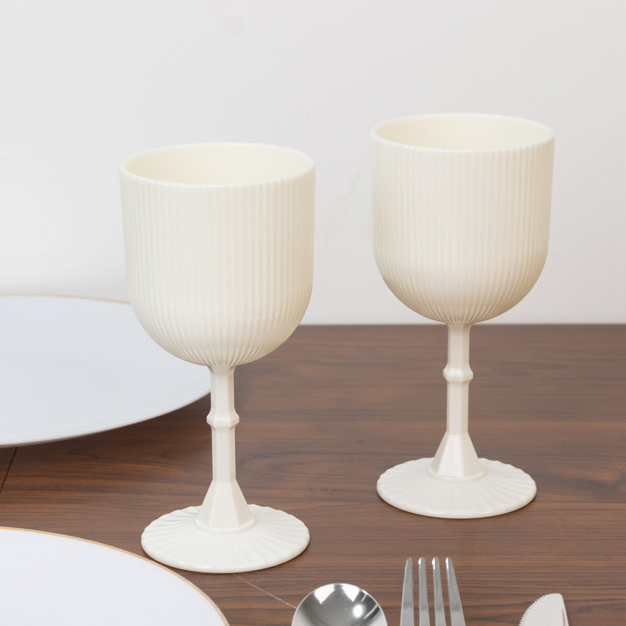 Elegant white ribbed goblets on a wooden table.