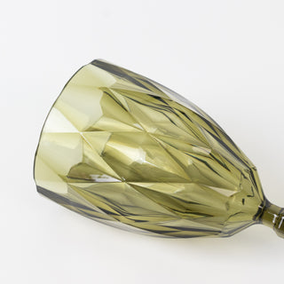 Green diamond-patterned wine glass on a plain background