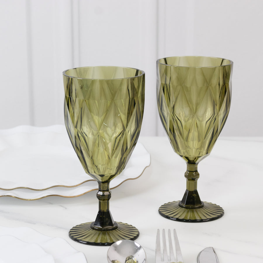 Elegant green patterned glassware set on a marble table.