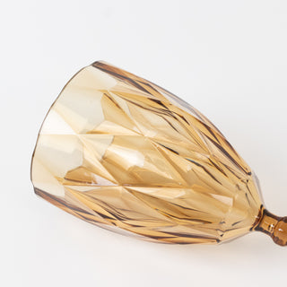 Amber crystal wine glass with intricate cut design