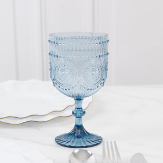 Blue decorative glass goblet on a marble surface.