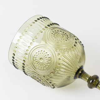 Green decorative glass goblet with intricate designs and a smooth finish