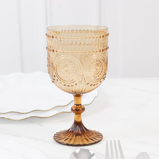 Amber glass goblet with intricate design and textured base