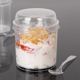 Clear plastic cup with yogurt, fruit, and granola, featuring a lid and spoon.