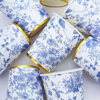 Blue floral paper cups with gold rims arranged creatively.