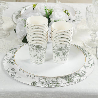 Stacked floral design cups and a decorative plate on a table setting.