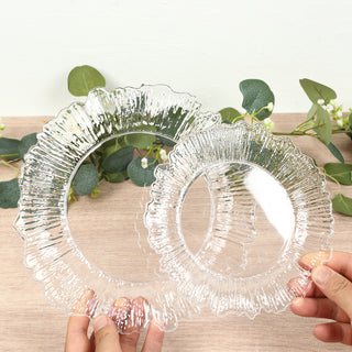 Two decorative clear plates with a ruffled edge design.
