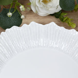 White decorative plate with a textured rim on a wooden surface.