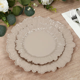 Set of elegant ruffled dinner plates in neutral tones.